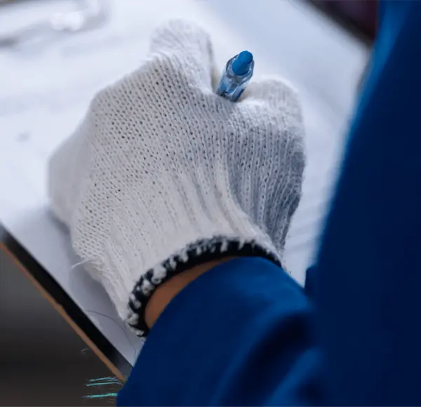 A person writing down on a piece of paper. A person writing down on a piece of paper.